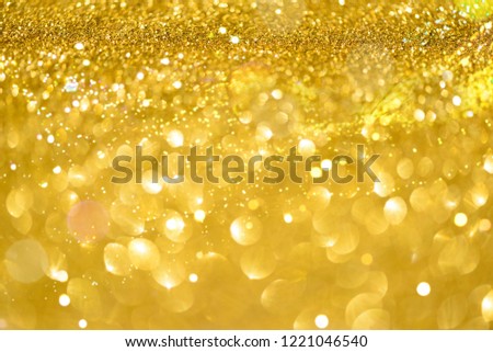 Sparkle glittering background. Holiday abstract texture. Christmas card with copy space, gold bokeh, defocused lights