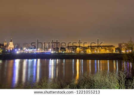 Reflection of the city with night lights in the lake