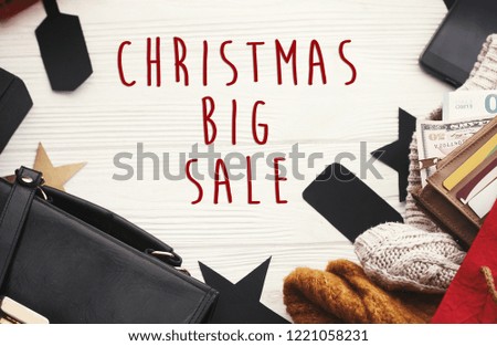 Christmas big sale text sign. Special discount christmas offer. Christmas shopping and seasonal sales. Gift boxes, credit cards and money in wallet, bags, clothes, tags on rustic wood
