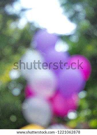 Blurred image of colorful balloons with nature for background, concept