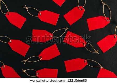 Black Friday sales discount composition. Red tags on black background. Flat lay, top view.