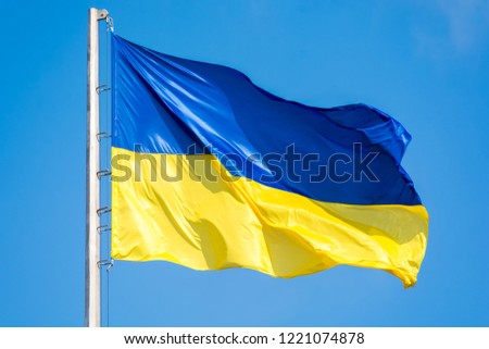 Ukrainian flag against a blue sky. Yellow and blue colors. National symbol of Ukraine. Royalty-Free Stock Photo #1221074878