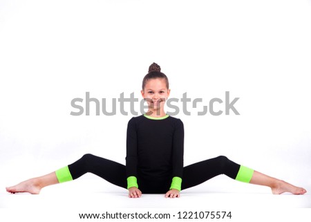 Teenager girl involved in rhythmic gymnastics. White background