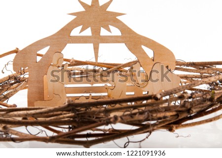 Christmas Nativity Scene of baby Jesus in the manger with Mary and Joseph in silhouette surrounded by the animals and wise men with the city of Bethlehem in the distance with