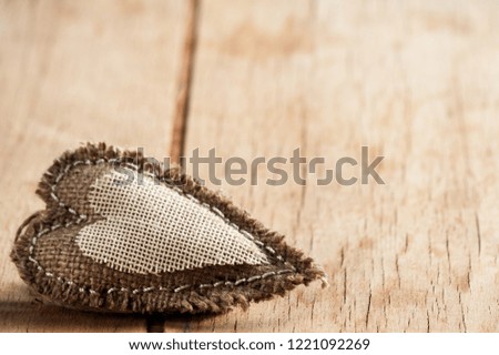 heart made of cloth on wooden background