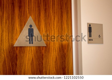 Men’s restroom sign on door in office building