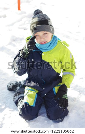 Children play outdoors in snow. Happy boysl playing on a winter walk in nature