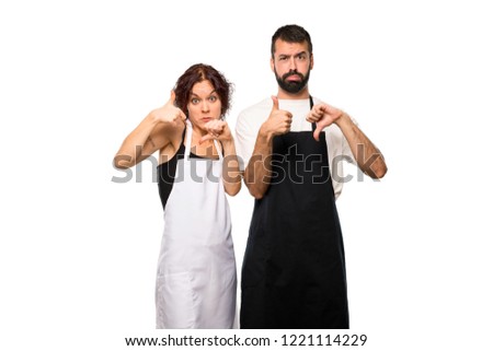 Couple of cooks making good-bad sign. Undecided between yes or not on isolated white background