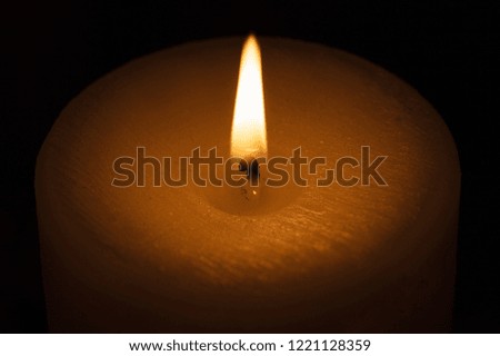 candle with flame in interior
