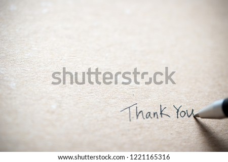 Hand writing thank you on piece of old grunge paper Royalty-Free Stock Photo #1221165316