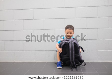 Cute little boy with suitcase and toy camera at airport.  Travel concept. Copy space. Background.