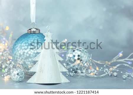christmas tree glass balls and toys on blue frozen background for winter holidays