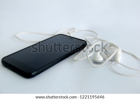 smartphone with earphones on a white background