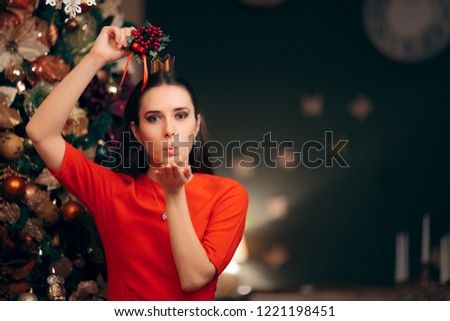 
Woman Holding Mistletoe Ready for a Kiss. Girlfriend happy to share a kiss at Xmas party celebration

