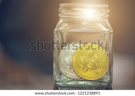 Golden Bitcoin on the table In a glass .Bitcoins and New Virtual money concept.Golden coin with icon letter B.Mining or block chain technology.