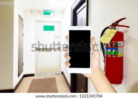 Man use mobile phone, blur image in the walkway in the hotel as as background.