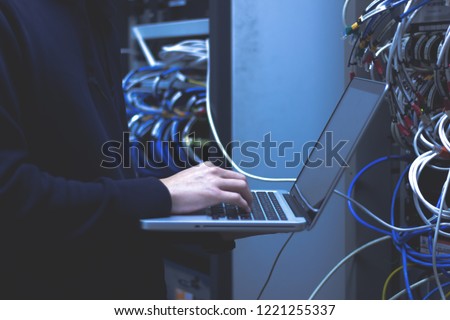 Close up of hands technician working on laptop in data center.Administrator working in data center configure . Royalty-Free Stock Photo #1221255337