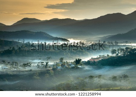 Beautiful images of the radiant dawn as the paradise with reflecting rays in the hills and mountains in the fanciful clouds in Lam Dong province, Vietnam.