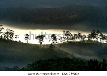 Beautiful images of the radiant dawn as the paradise with reflecting rays in the hills and mountains in the fanciful clouds in Lam Dong province, Vietnam.