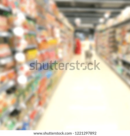 Abstract blur of aisle in supermarket with customers and department store interior for background