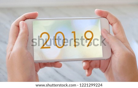 2019, happy new year banner on smart phone device screen background, new year greeting card banner, communication and technology concept