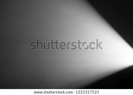 white color wide lens projector with light beam for movie and cinema at night . smoke texture spotlight . screening for multimedia . black background . Royalty-Free Stock Photo #1221317521