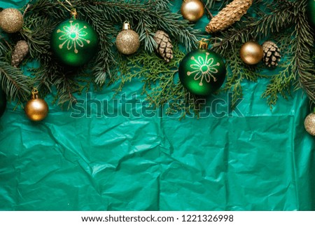 gift boxes on green table and fir branches. box with ribbon bow present on holiday wrapped paper. minimalistic Christmas gifts and balls