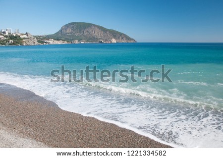 Landscape view of a pebble beach at Gurzuf resort in Crimea with Ayu-Dag or Bear mountain in the background, Russia