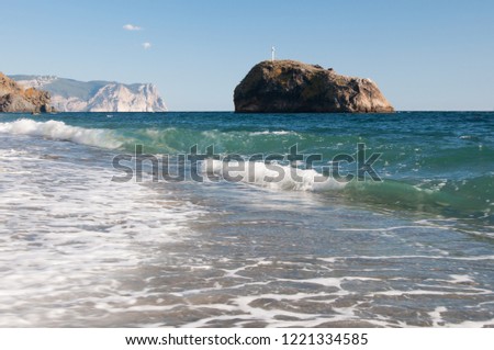 Jasper beach near Sevastopol with the Holy Phenomenon rock and Aiya cape in the background, Crimea, Russian Federation