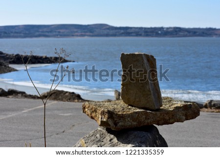 rocks balancing in front of a lake