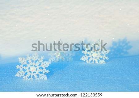 Decorative snowflakes on snow