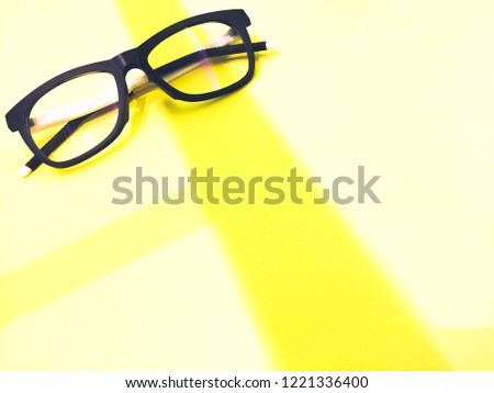 Black and white glasses on the yellow line space background.