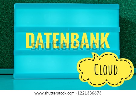 Illuminated board with the inscription Cloud and in german Datenbank in english database