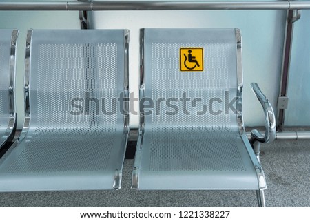 Stainless steel chairs in the train station with disabled signage to facilitate the use of train services for the disabled.Thailand