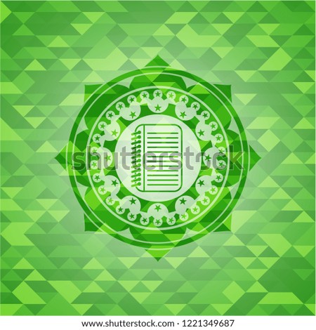 note book icon inside realistic green emblem. Mosaic background