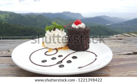dessert on white dish top of wood table front nice view.