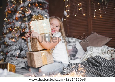Cute little child holding christmas presents