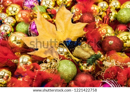 Christmas vibrant colorful wallpaper background texture of balls and decorations for the celebration tree and dry leafs.