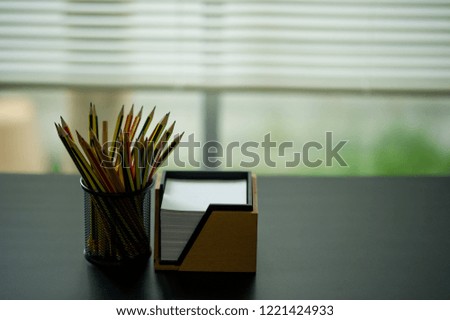 Pencil and note Placed on the executive desk. Placed by the window
