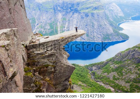 Trolltunga or Troll Tongue is a rock formation  at the Hardangerfjord near Odda town in Hordaland, Norway Royalty-Free Stock Photo #1221427180