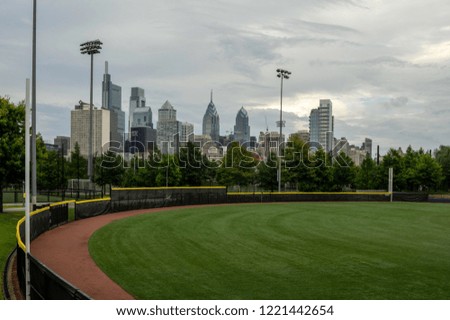 A sports field in the City with the city skyline in the background.