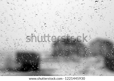 Blurred view through car window on winter season in black and white. Seasonal background texture for design.
