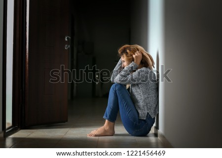 Woman having panic attack indoors Royalty-Free Stock Photo #1221456469