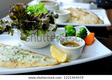 Grilled Pangasius with white cream sauce, serve with fresh salad.