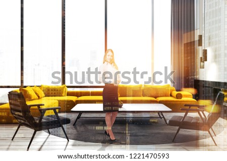 Woman in panoramic window living room interior with white walls, wooden floor, yellow sofa and two black armchairs near the coffee table. Toned image double exposure