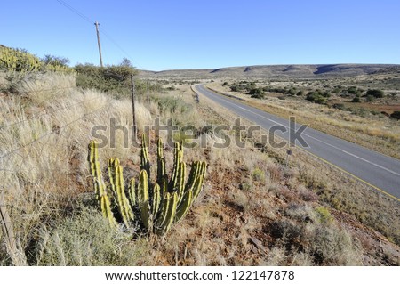 Route N10 main road between Upington and Prieska in the Northern Cape Province, South Africa. The  arid karoo gives way to the kalahari desert  as one travels north Royalty-Free Stock Photo #122147878