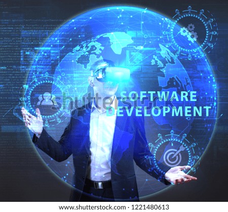 The concept of business, technology, the Internet and the network. A young entrepreneur working on a virtual screen of the future and sees the inscription: Software development
