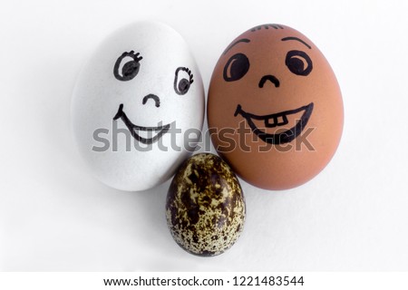 Funny eggs imitating a happy mixed family with versicolored baby on white background