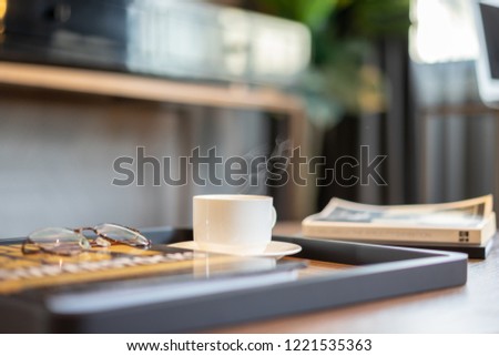 Cup of coffee on the desk in the morning.
