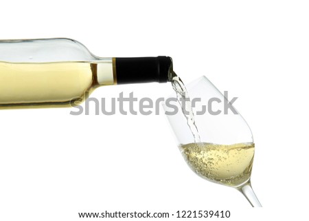 Pouring of wine from bottle into glass on white background